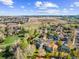 An aerial shot displays neighborhood homes beside a large development area at 10915 Acadia Ln, Parker, CO 80138
