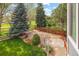 View of a backyard with trees and landscaping from the deck of the house at 10915 Acadia Ln, Parker, CO 80138