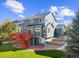 Beautifully landscaped backyard with deck, stone stairs, and a well-maintained lawn at 10915 Acadia Ln, Parker, CO 80138