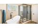 Modern bathroom featuring a freestanding tub, glass-enclosed shower, and sleek fixtures at 10915 Acadia Ln, Parker, CO 80138