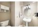 Small half-bath featuring a pedestal sink and toilet at 10915 Acadia Ln, Parker, CO 80138