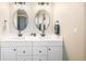 Bright bathroom featuring a double vanity with stylish lighting and modern fixtures at 10915 Acadia Ln, Parker, CO 80138