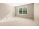 Sun-filled bedroom with neutral walls and carpet, featuring a large window at 10915 Acadia Ln, Parker, CO 80138
