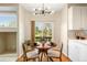Cozy breakfast nook with backyard views, a modern light fixture, and seating for four at 10915 Acadia Ln, Parker, CO 80138
