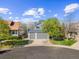 An eye-level view showcases a well-maintained two-story home with an attached two-car garage and a beautiful lawn at 10915 Acadia Ln, Parker, CO 80138