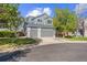 Charming gray two-story home featuring a two-car garage and well-maintained front lawn with mature trees at 10915 Acadia Ln, Parker, CO 80138