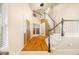 Inviting foyer featuring hardwood floors, staircase, and an elegant light fixture, creating a welcoming entry at 10915 Acadia Ln, Parker, CO 80138