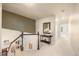 Upstairs hallway featuring carpet, railing, and console table at 10915 Acadia Ln, Parker, CO 80138