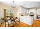 Modern kitchen with white cabinetry, stainless steel appliances, and an adjacent dining area with sliding glass doors at 10915 Acadia Ln, Parker, CO 80138