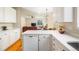 Kitchen featuring white cabinets, quartz countertops, stainless appliances, and hardwood floors at 10915 Acadia Ln, Parker, CO 80138
