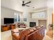 Inviting living room with a fireplace, ceiling fan, and ample natural light at 10915 Acadia Ln, Parker, CO 80138