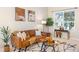 Bright living room featuring a comfortable leather sofa, stylish decor, and ample natural light from a large window at 10915 Acadia Ln, Parker, CO 80138