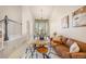 Bright living room showcasing a comfortable leather couch, stylish decor, and a dining area with bay windows at 10915 Acadia Ln, Parker, CO 80138