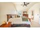 Relaxing main bedroom featuring a ceiling fan, natural light, and a dresser with a mirror at 10915 Acadia Ln, Parker, CO 80138