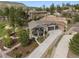 Stunning aerial view of home with an inviting driveway, lush landscaping, and hillside terraces at 20243 High Pines Dr, Monument, CO 80132