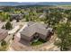 Aerial view of a house with an expansive yard, landscaping and a circular driveway on a sunny day at 20243 High Pines Dr, Monument, CO 80132