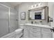Bathroom features a glass shower, white marble vanity, and framed mirror at 20243 High Pines Dr, Monument, CO 80132