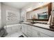 Bright bathroom features double sinks, a soaking tub, and a large, decorative framed mirror at 20243 High Pines Dr, Monument, CO 80132