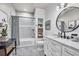 Updated bathroom features shiplap walls, a tub shower, and a marble topped vanity at 20243 High Pines Dr, Monument, CO 80132