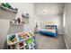 bedroom with bright blue bed, and storage shelves for toys at 20243 High Pines Dr, Monument, CO 80132
