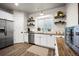 Updated kitchen features stainless steel appliances, white cabinetry, butcher block counters, and wood floor at 20243 High Pines Dr, Monument, CO 80132