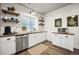 Updated kitchen features white cabinetry, butcher block counters, and stainless steel appliances at 20243 High Pines Dr, Monument, CO 80132