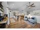 Bright open concept living room and kitchen with hardwood floors, white cabinets, and comfortable seating at 20243 High Pines Dr, Monument, CO 80132