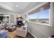 Sunlit living room with stone fireplace, comfortable seating, and expansive mountain view at 20243 High Pines Dr, Monument, CO 80132