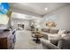 Bright living room with a large sectional, desk area, and sliding glass doors to the outside at 20243 High Pines Dr, Monument, CO 80132