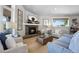 Cozy living room with a stone fireplace, a large window, and comfortable seating at 20243 High Pines Dr, Monument, CO 80132