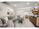 Spacious living room featuring a large sectional sofa, round coffee table, and stylish decor at 20243 High Pines Dr, Monument, CO 80132