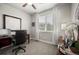 Office with large window, dark wood desk, neutral carpet, and white drapes at 20243 High Pines Dr, Monument, CO 80132
