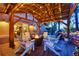Covered patio area with outdoor seating, fire pit, and cafe lights for cozy outdoor gatherings at 20243 High Pines Dr, Monument, CO 80132