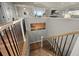 Staircase with black metal railings and wood trim leading to a lower level with sunset art at 20243 High Pines Dr, Monument, CO 80132