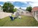 Backyard featuring lawn, deck and firepit area with Adirondack chairs at 12104 Ivanhoe Ct, Brighton, CO 80602