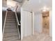 Finished basement staircase with gray carpet, white walls, and utility room at 12104 Ivanhoe Ct, Brighton, CO 80602