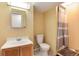 Compact bathroom with single sink vanity, toilet, and shower with curtain at 12104 Ivanhoe Ct, Brighton, CO 80602