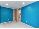 Bright bedroom featuring two doors and a blue accent wall at 12104 Ivanhoe Ct, Brighton, CO 80602