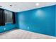 Bright bedroom with a black window shade and blue accent wall at 12104 Ivanhoe Ct, Brighton, CO 80602