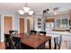 The dining area is adjacent to the kitchen, featuring a rustic wooden table with black chairs at 12104 Ivanhoe Ct, Brighton, CO 80602