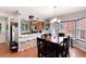 Open dining area and kitchen offer bar seating, natural light, and modern accents at 12104 Ivanhoe Ct, Brighton, CO 80602