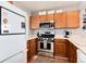Kitchen featuring stainless steel appliances, including a gas range and microwave, with ample counter space at 12104 Ivanhoe Ct, Brighton, CO 80602