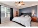 Comfortable main bedroom features a ceiling fan, large window, and carpeted floors at 12104 Ivanhoe Ct, Brighton, CO 80602