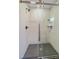 Shower area featuring gray tiling, glass doors, and modern fixtures at 5614 Yarrow St, Arvada, CO 80002