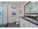 Modern bathroom with sleek vanity, glass-enclosed shower, and elegant fixtures at 5614 Yarrow St, Arvada, CO 80002