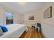 Comfortable bedroom with hardwood floors, natural light, and unique artwork at 5614 Yarrow St, Arvada, CO 80002