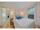 Bright bedroom with wood floors, updated window and white bedding at 5614 Yarrow St, Arvada, CO 80002