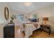Cozy bedroom features hardwood floors, natural light, and stylish decor at 5614 Yarrow St, Arvada, CO 80002