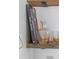 Close-up shot showcases a decanter, glasses, and a book on a rustic wooden shelf; home decor at 5614 Yarrow St, Arvada, CO 80002