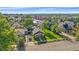 Charming home features a well-manicured lawn and inviting porch with a red door and blue chairs at 5614 Yarrow St, Arvada, CO 80002